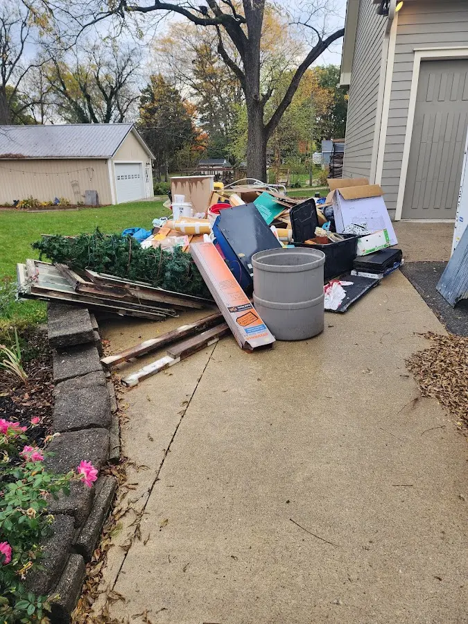 Dumpster being loaded with debris for Demolition Dumpster Rental in Commerce